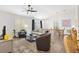 Cozy living room with large windows, comfortable seating, and an inviting dining area at 1225 Eunice St, The Villages, FL 34762