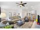 Open-concept living room features modern decor, neutral tones, and seamless flow to the kitchen at 1225 Eunice St, The Villages, FL 34762