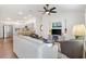 Inviting living area with open layout, wood floors, and seamless flow into the kitchen at 1225 Eunice St, The Villages, FL 34762