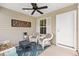 Relaxing screened porch featuring a ceiling fan, comfortable seating, and tranquil outdoor view at 1225 Eunice St, The Villages, FL 34762