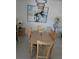 Bright dining area with a modern chandelier, neutral decor, and a large abstract art piece at 130 Napoli Dr, Davenport, FL 33897