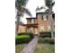 Charming two-story townhouse featuring manicured landscaping and a welcoming front entrance with a brick walkway at 130 Napoli Dr, Davenport, FL 33897