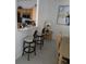 Cozy eat-in kitchen featuring breakfast bar, black appliances, wood cabinets, and modern accents at 130 Napoli Dr, Davenport, FL 33897