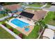 Aerial shot of a home highlighting the backyard oasis with a pool, spa, and a patio area perfect for entertaining at 1414 Cove Pl, Tavares, FL 32778
