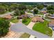 Aerial view of a home showing its location in a cul-de-sac, along with a well-maintained lawn at 1414 Cove Pl, Tavares, FL 32778