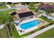 Aerial shot of a home highlighting the backyard oasis with a pool, spa, and a patio area perfect for entertaining at 1414 Cove Pl, Tavares, FL 32778
