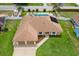 Beautiful aerial view of a home, showcasing its well-maintained lawn and three car garage at 1414 Cove Pl, Tavares, FL 32778