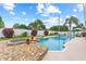 Backyard featuring a pool, spa, stone accents, patio, landscaping, and privacy fence at 1414 Cove Pl, Tavares, FL 32778