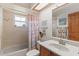 Charming bathroom features a skylight, shower-tub combination, and decorative starfish accents at 1414 Cove Pl, Tavares, FL 32778