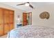 Bedroom featuring a ceiling fan, wood floors, closet, and tasteful seaside decor at 1414 Cove Pl, Tavares, FL 32778