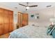 Comfortable bedroom with wood floors, ceiling fan, and decorative coastal-themed accessories at 1414 Cove Pl, Tavares, FL 32778