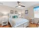 Relaxing bedroom with wood floors, ceiling fan, stylish decor, and ample natural light at 1414 Cove Pl, Tavares, FL 32778