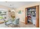 Cozy breakfast nook featuring a glass table, floral chairs, and a convenient pantry for storage at 1414 Cove Pl, Tavares, FL 32778