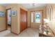Inviting foyer with tile flooring, decorative front door, closet and light fixtures at 1414 Cove Pl, Tavares, FL 32778