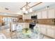 Open concept kitchen with breakfast nook, white cabinets, granite countertops, and stainless appliances at 1414 Cove Pl, Tavares, FL 32778