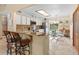 Bright kitchen featuring a breakfast bar, white cabinets, stainless steel appliances, and eat-in nook at 1414 Cove Pl, Tavares, FL 32778