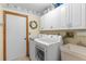 Functional laundry room with washer, dryer, utility sink, and ample cabinet space for storage at 1414 Cove Pl, Tavares, FL 32778