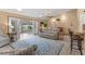 Open floor plan living room leads to pool area, with tile floors, kitchen bar and comfortable seating at 1414 Cove Pl, Tavares, FL 32778