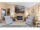 Cozy living room featuring a stone fireplace, beach themed decor, and comfortable seating area at 1414 Cove Pl, Tavares, FL 32778