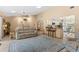 Bright living room featuring an open concept, a kitchen bar, tile flooring, and comfortable seating at 1414 Cove Pl, Tavares, FL 32778