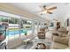 Bright living room with pool views, tile flooring, comfortable seating, and abundant natural light at 1414 Cove Pl, Tavares, FL 32778