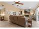 Open concept living room with fireplace, tile flooring, ceiling fan, and comfortable leather sofa at 1414 Cove Pl, Tavares, FL 32778