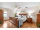 Spacious main bedroom with hardwood floors, a ceiling fan, and tasteful decor at 1414 Cove Pl, Tavares, FL 32778