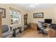 Bright office space with hardwood floors, a large window and a traditional desk setup at 1414 Cove Pl, Tavares, FL 32778
