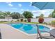 Inviting backyard with sparkling pool, lush landscaping, and a serene seating area at 1414 Cove Pl, Tavares, FL 32778