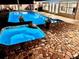 A luxurious pool area at night featuring a spa and beautiful stone accents, perfect for relaxing and entertaining guests at 1414 Cove Pl, Tavares, FL 32778