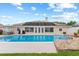 Spacious backyard features a beautiful pool, perfect for relaxing and entertaining guests at 1414 Cove Pl, Tavares, FL 32778