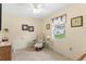 Cozy sitting room with a comfortable chair, vanity and natural light from the window at 1414 Cove Pl, Tavares, FL 32778