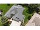 Overhead shot of the house displaying the roof, driveway, and the well-manicured lawn at 1553 Lynchburg Loop, The Villages, FL 32162