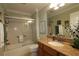 Well-maintained bathroom featuring a glass-enclosed shower, granite vanity, and neutral tones at 1553 Lynchburg Loop, The Villages, FL 32162