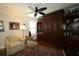 Cozy room with custom built-in shelving and storage, ceiling fan, and comfortable chair at 1553 Lynchburg Loop, The Villages, FL 32162