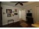 Bedroom with lovely decor, wood floors, ceiling fan, and ample wall decor at 1553 Lynchburg Loop, The Villages, FL 32162