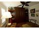 Charming room with custom built-ins, ceiling fan, and comfortable seating area at 1553 Lynchburg Loop, The Villages, FL 32162