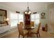 Cozy breakfast nook featuring a glass top table, woven chairs, shuttered windows and a display cabinet at 1553 Lynchburg Loop, The Villages, FL 32162