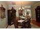 Elegant dining room with hardwood floors, chandelier lighting, and classic decor at 1553 Lynchburg Loop, The Villages, FL 32162