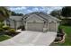 Well-maintained home exterior with a three-car garage and manicured landscaping in a desirable neighborhood at 1553 Lynchburg Loop, The Villages, FL 32162