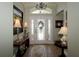 Inviting foyer features decorative glass door, tiled floor, and elegant lighting at 1553 Lynchburg Loop, The Villages, FL 32162