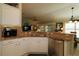 Open concept kitchen with granite counters and stainless steel appliances, perfect for entertaining at 1553 Lynchburg Loop, The Villages, FL 32162
