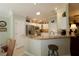 Eat-in kitchen featuring granite countertops, stainless steel appliances, and white cabinetry at 1553 Lynchburg Loop, The Villages, FL 32162