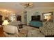Open living room featuring neutral paint, lots of seating, and hardwood floors at 1553 Lynchburg Loop, The Villages, FL 32162