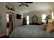 Spacious bedroom with decorative molding, a four-poster bed, and private bathroom access at 1553 Lynchburg Loop, The Villages, FL 32162