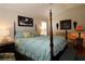 Cozy main bedroom featuring a four-poster bed and sitting area, perfect for relaxation at 1553 Lynchburg Loop, The Villages, FL 32162