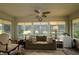 Cozy sunroom bathed in natural light from large windows, perfect for relaxing and enjoying the view at 1553 Lynchburg Loop, The Villages, FL 32162