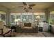 Relaxing sunroom filled with natural light through the large windows overlooking the landscape at 1553 Lynchburg Loop, The Villages, FL 32162