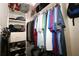 Functional walk-in closet with organized shelves, hanging rods, and shoe storage at 1553 Lynchburg Loop, The Villages, FL 32162