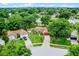 Well-maintained single-story home with a red garage door, lush lawn, mature trees, and an inviting driveway at 15916 Indian Wells Ct, Clermont, FL 34711